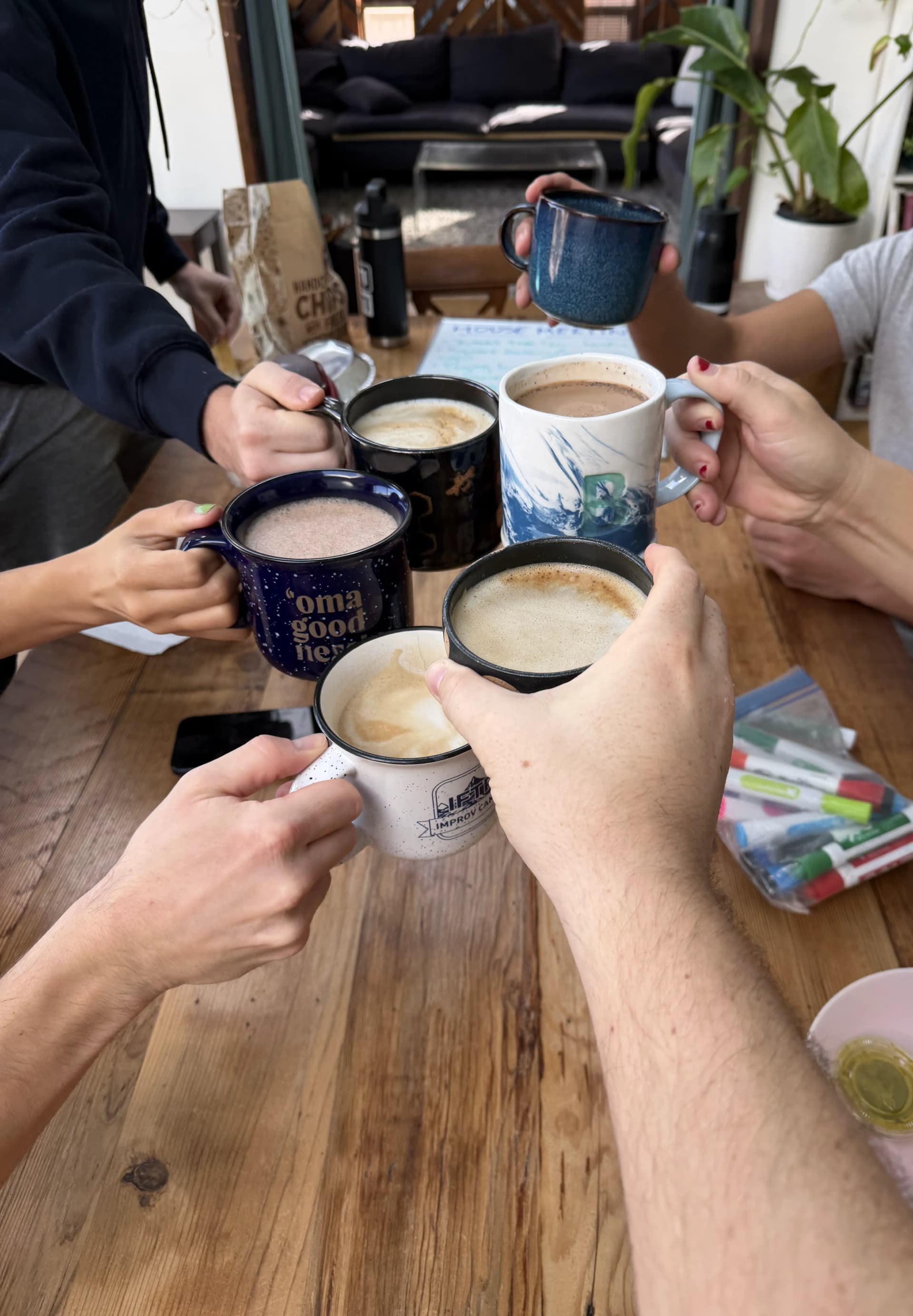 Housemates cheersing lattes at Bellbottom House